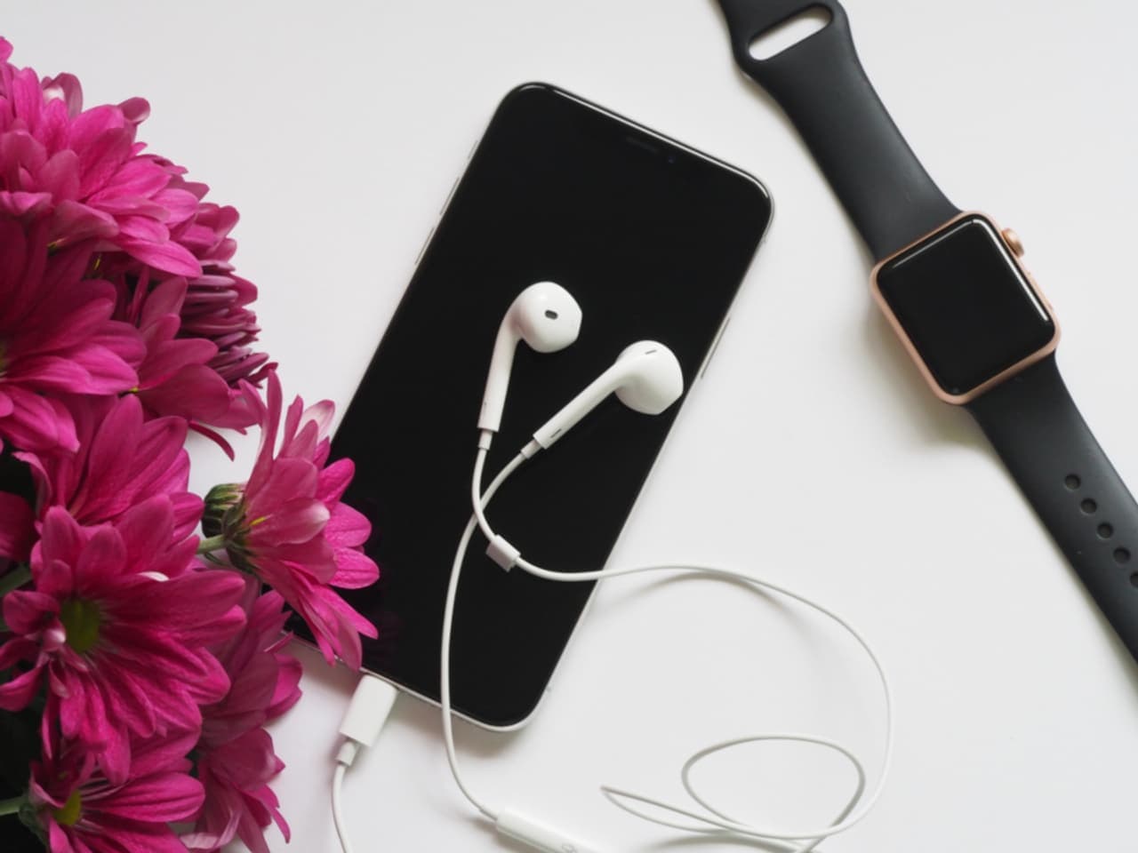 A watch and headphones on a desk