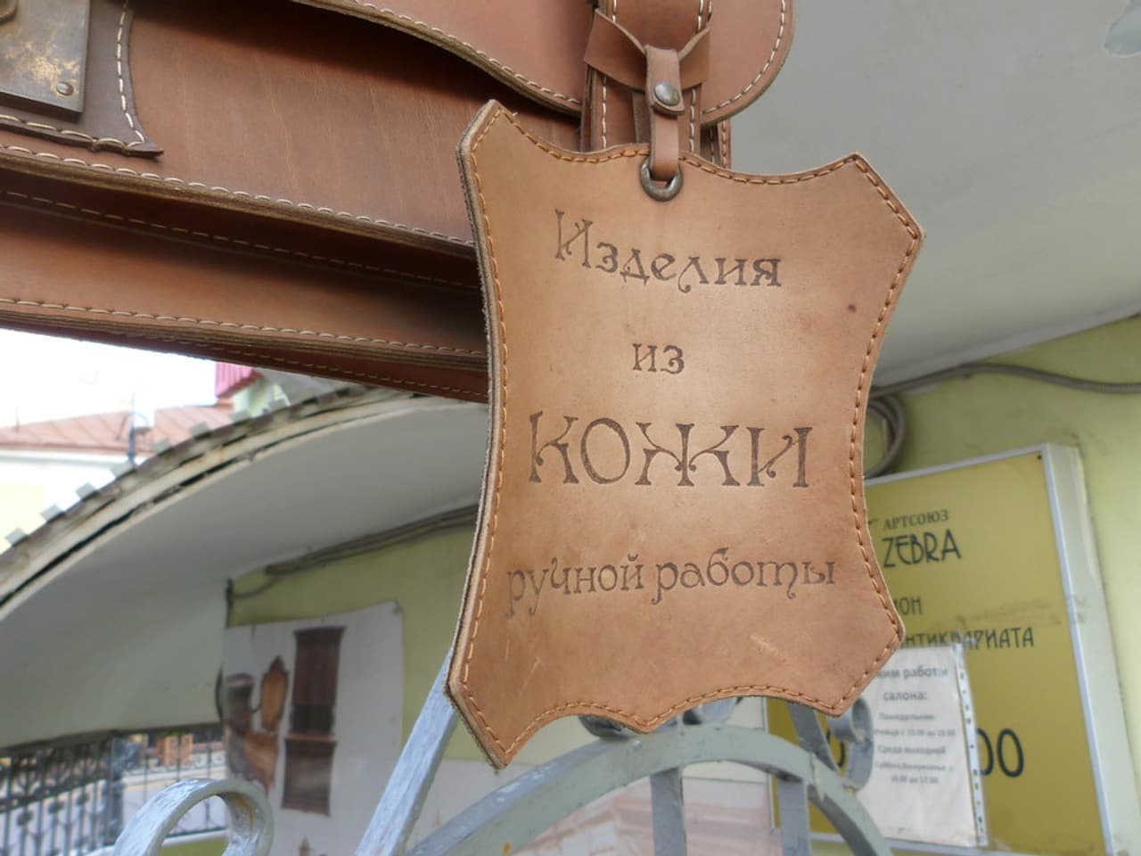 A wallet, knife and watch on a wooden surface