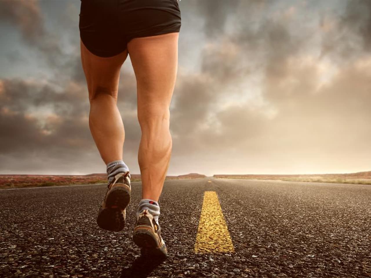 Running shoes on a road at dawn