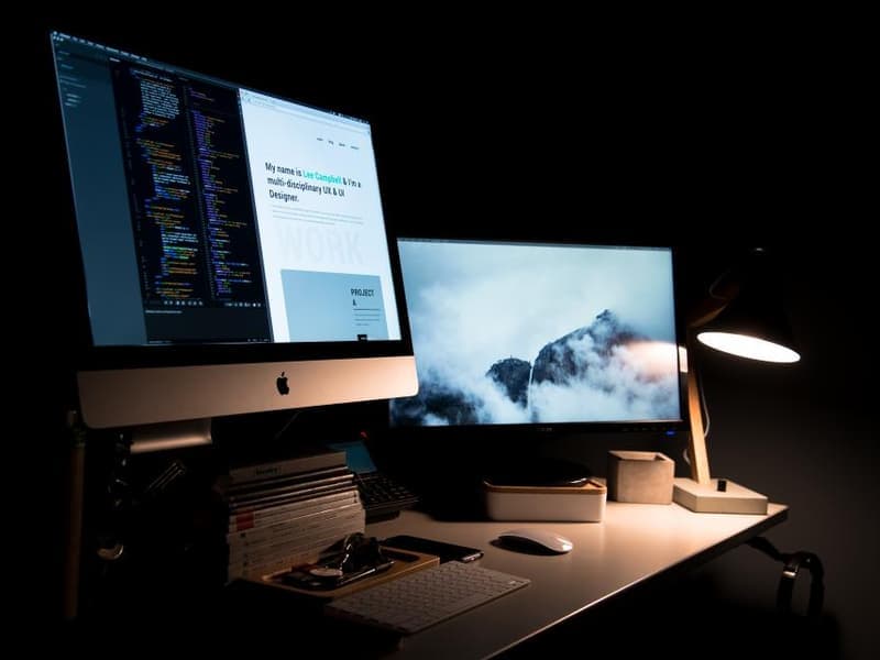 A desk lamp beside a notebook