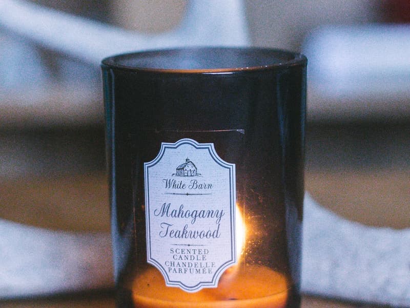 A lit candle in a glass vessel