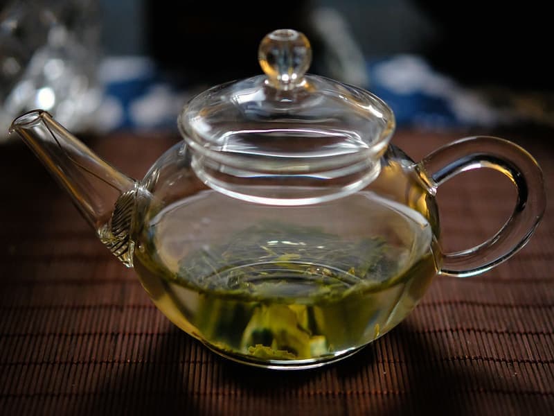A glass teapot with loose-leaf tea