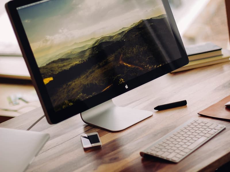 A wireless mouse beside a laptop