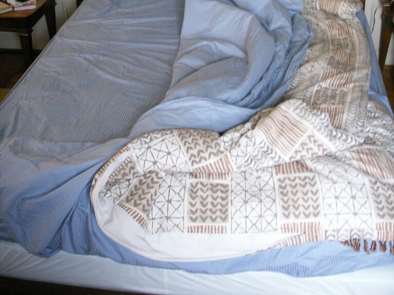 A blanket folded on a bed